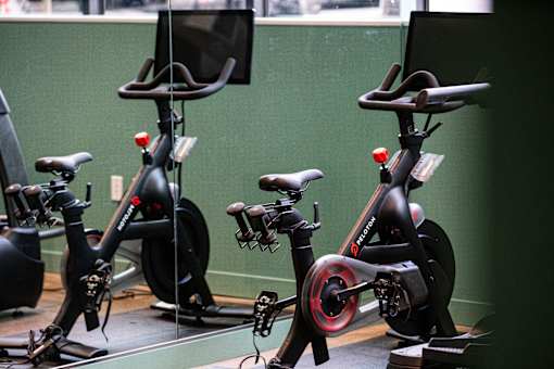 a row of exercise bikes in a room with a green wall at Brookland Apartments, Portland, 97202