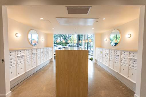 a dressing room with white lockers and a table in the middle at Brookland Apartments, Portland, Oregon