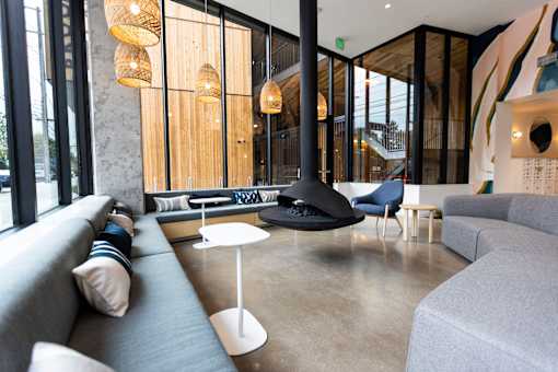 a living room with couches and chairs and a fireplace at Brookland Apartments, Portland, 97202