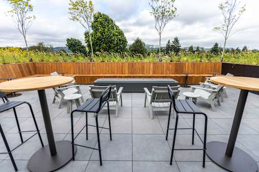 a patio with tables and chairs and a pool at Brookland Apartments, Oregon
