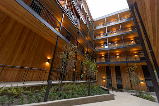 A modern building with wooden balconies and railings at Brookland Apartments, Oregon 97202