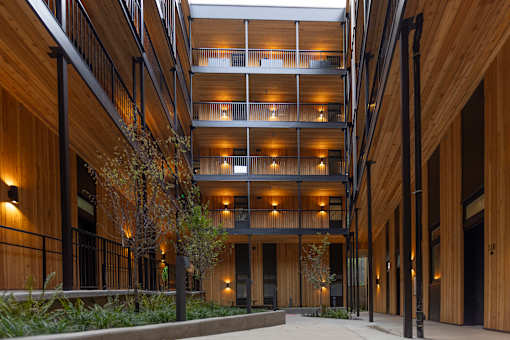 a large building with wooden walls and floors and a sidewalk at Brookland Apartments, Portland, 97202