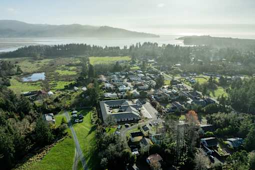 A small town with a large body of water in the background.