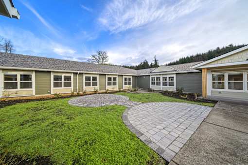 A sunny day at a residential area with houses and a green lawn.