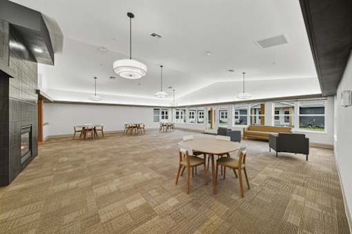 A room with a long table and chairs.