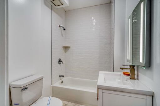 A white bathroom with a toilet, sink, and bathtub at Clay & Tiffany, Portland, 97201