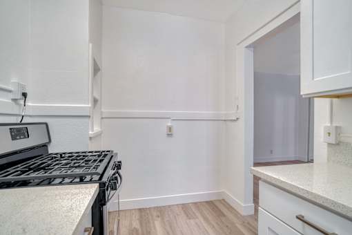 A kitchen with a stove top oven and a counter top at Clay & Tiffany, Portland, 97201