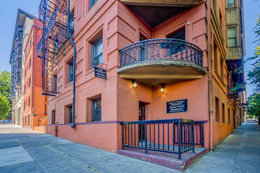 A red building with a balcony and a sign that says at Clay & Tiffany, Portland, 97201
