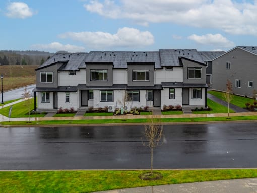 Exterior view of building with bushes and a sidewalk at Thrive at Green Mountain, Camas, WA