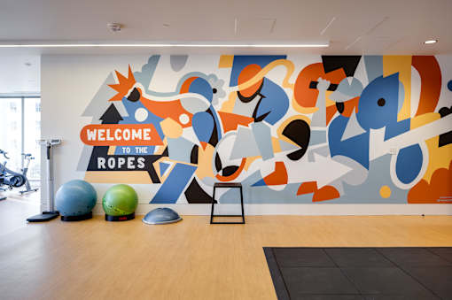 A gym with a sign that says "Welcome to the Ropes".