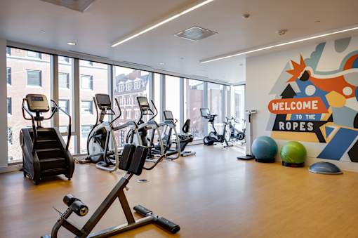 A gym with a sign that says "Welcome to the Ropes".