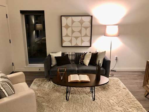 A living room with a grey couch and a coffee table.