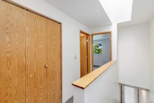 A wooden door with a mirror on the wall.at Alder Creek Apartments, Washington, 98682