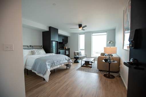 a bedroom with a bed and a living room with a window at Analog Tacoma, Washington 98402