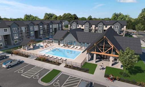 A large building with a pool in front of it.