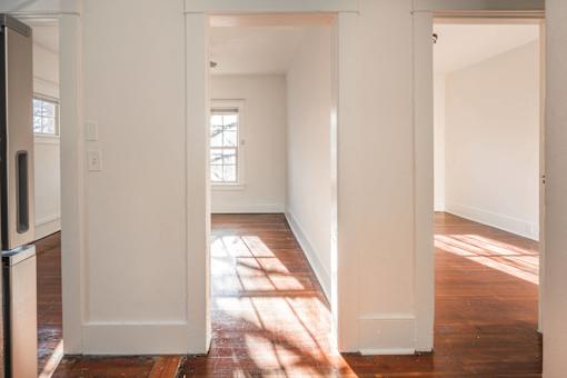 A white hallway with sunlight coming through the window at Midtown Apartments, Oregon, 97209
