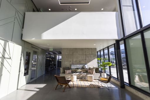 a living room with large windows and a table and chairs at Moraine, Tacoma, WA 98402