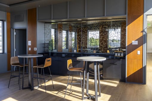 a dining area with tables and chairs in a lobby at Moraine, Tacoma, WA 98402