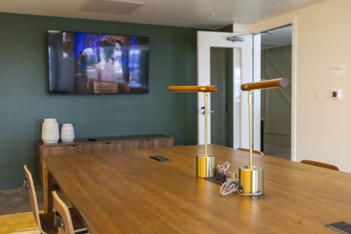 a dining room with a wooden table and a tv on the wall at Moraine, Tacoma, WA
