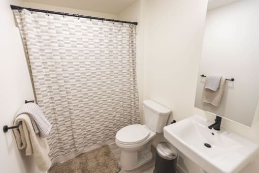 a bathroom with a shower toilet and sink at Moraine, Tacoma