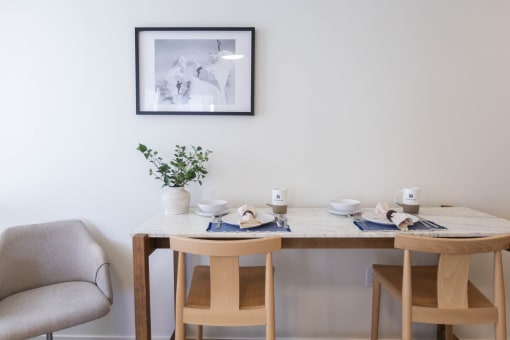 a dining room with a table and chairs and a picture on the wall at Moraine, Washington 98402