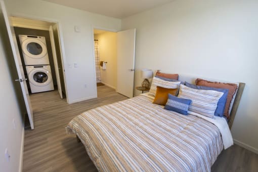 a bedroom with a bed and a washing machine at Moraine, Tacoma, Washington