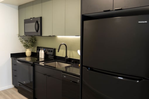 a kitchen with a sink and a refrigerator at Moraine, Tacoma, Washington 98402