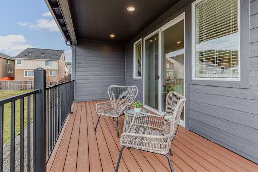 Outdoor patio with a chair and table at Thrive at Green Mountain, Camas, WA, 98607