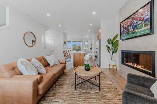 Living room with a fireplace and a television at Thrive at Green Mountain, Camas