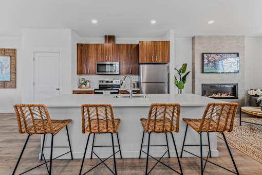 Kitchen with a white countertop and wooden chairs at Thrive at Green Mountain, Washington