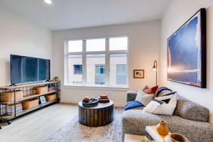 a living room filled with furniture and a flat screen tv at Holm at Sellwood, Oregon, 97202