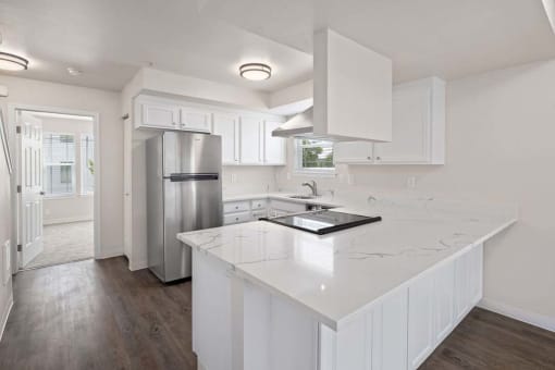 a kitchen with a white counter top and a refrigerator