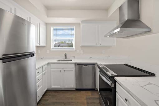 a kitchen with a stove top oven next to a refrigerator
