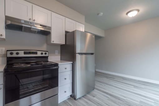 a kitchen with a stove and a refrigerator