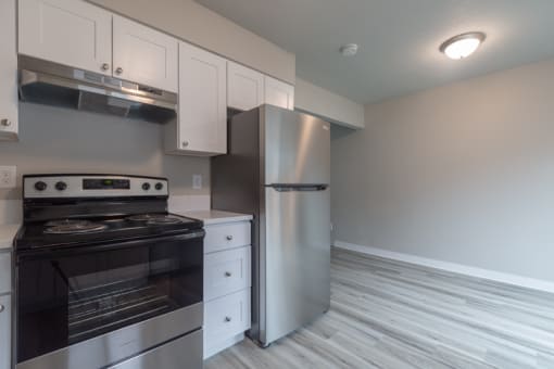 a kitchen with a stove and a refrigerator