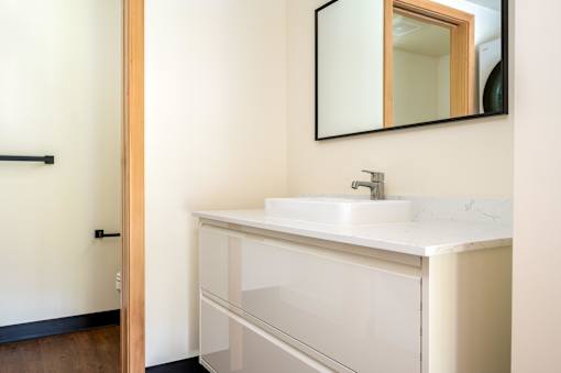 White sink with a mirror above it at Atomic Orchard Experiment, Oregon