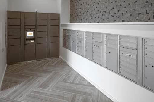 A row of mailboxes are lined up on a wall.