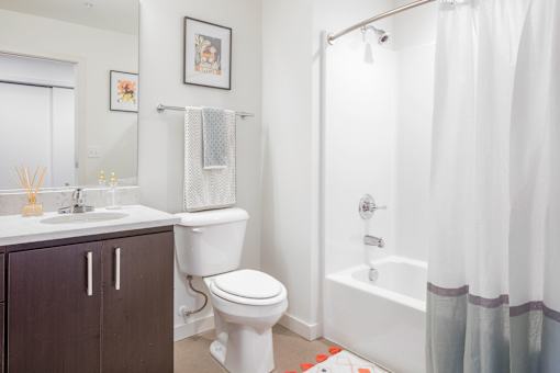 A white toilet sits next to a sink in a bathroom.