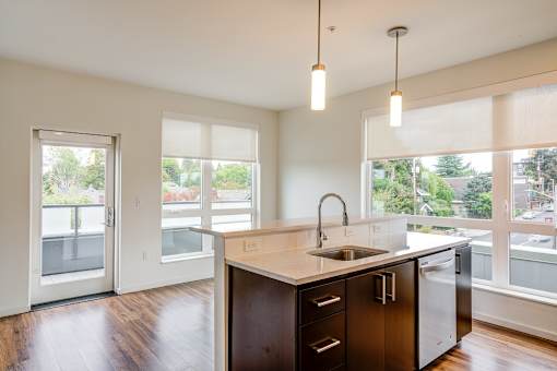 A kitchen with a sink and a refrigerator.