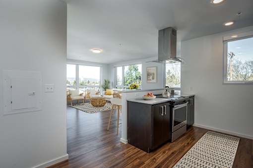 A kitchen with a black stove top oven and a black refrigerator.
