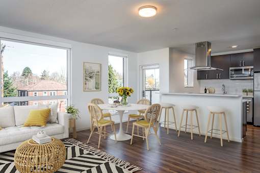 A modern kitchen with a dining table and chairs.