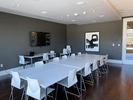 A conference room with a long table and chairs.