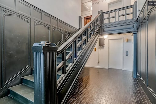 A staircase with a metal railing and wooden steps at Clay & Tiffany, Portland, 97201