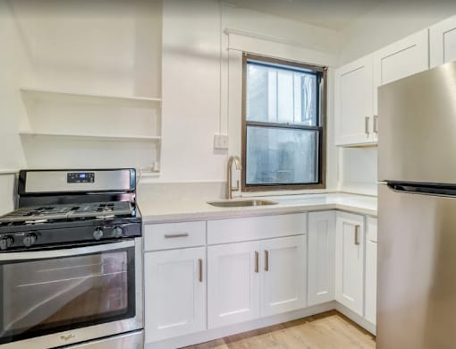 A modern kitchen with a stove, sink, and refrigerator at Clay & Tiffany, Portland, 97201