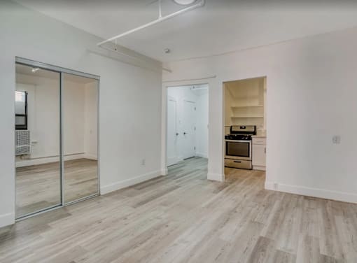 A room with a wooden floor and a kitchenette in the corner at Clay & Tiffany, Portland, 97201