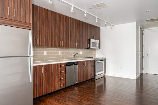 A kitchen with wooden cabinets and a white refrigerator.