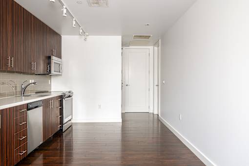 A kitchen with wooden cabinets and a white counter top.