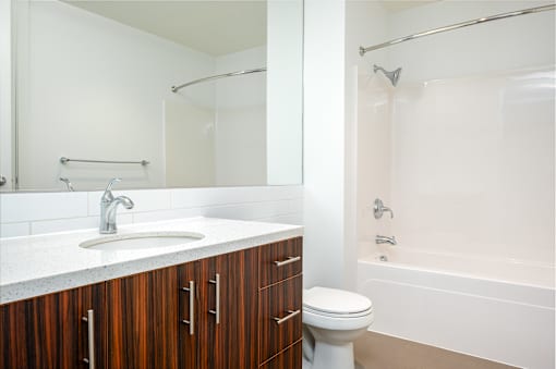A white bathroom with a sink, toilet, and bathtub.
