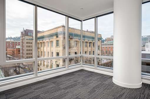 A large room with a view of a cityscape through the windows.