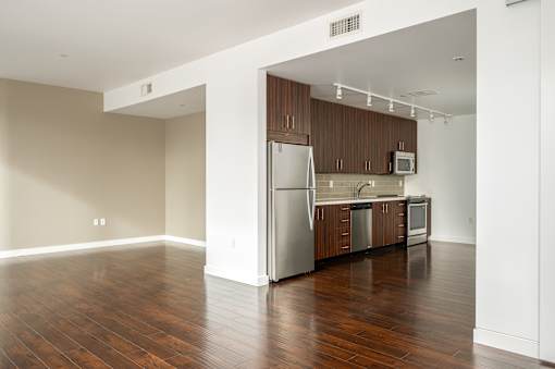 A kitchen with wooden cabinets and a refrigerator.